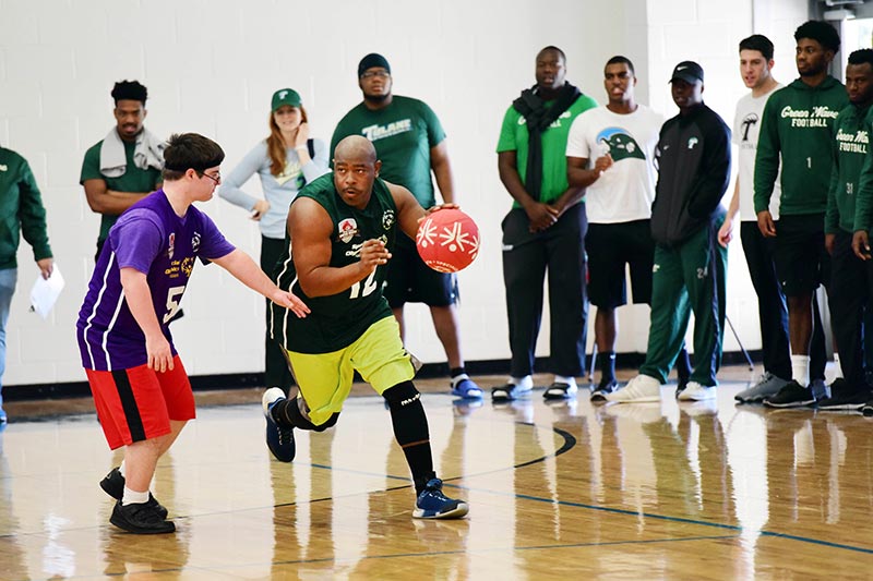 A player dribbles the basketball during the 2017 Special Olympics Rivalry Game